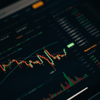 A candlestick chart visualizing currency exchange fluctuations through alternating red and green bars.