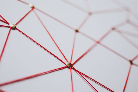 Linking entities. Network, networking, social media, connectivity, internet communication abstract. Web of red thread on white background.